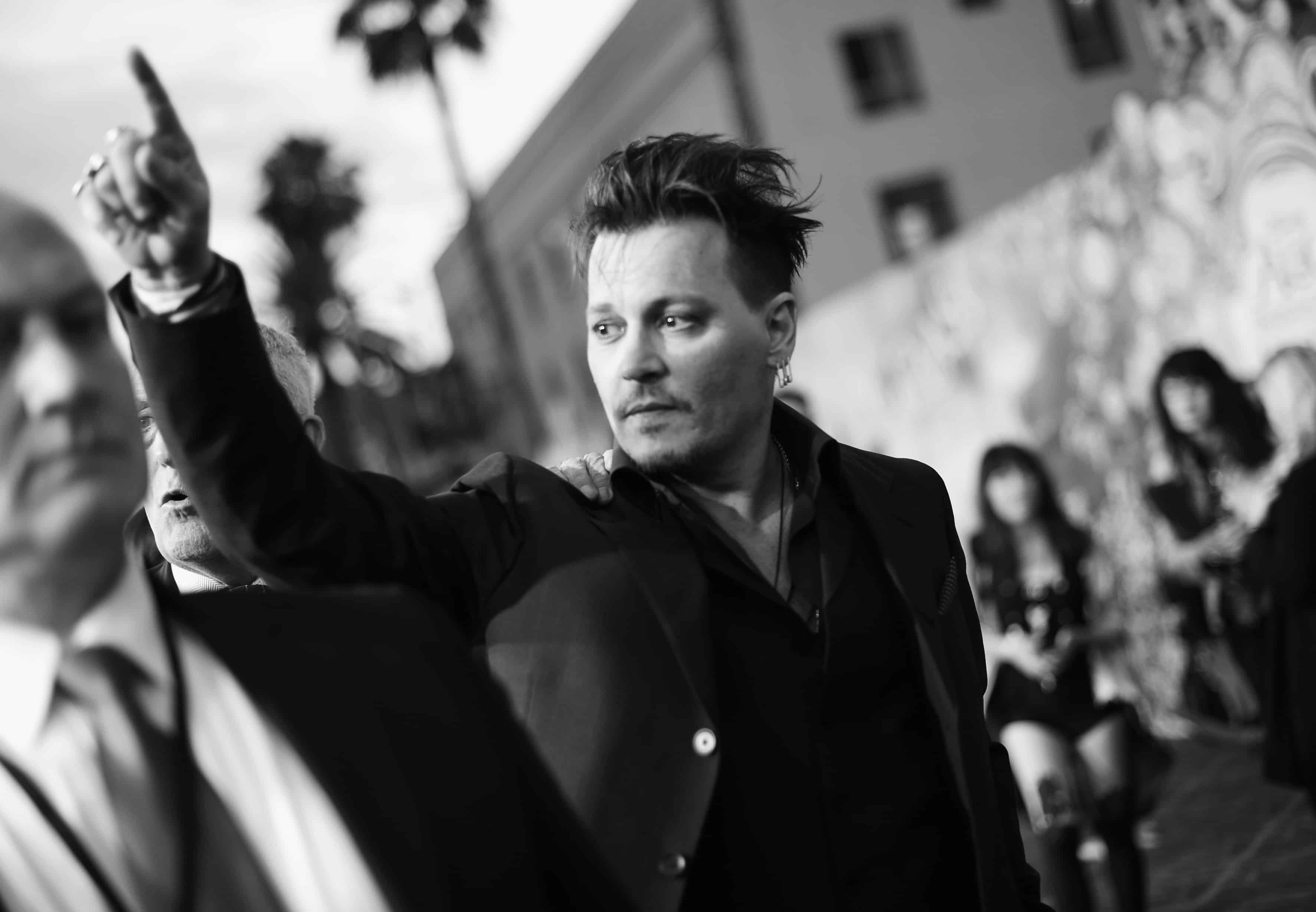 HOLLYWOOD, CA - MAY 23: (EDITORS NOTE: Image has been shot in black and white. Color version not available.) Actor Johnny Depp attends Disneys 'Alice Through the Looking Glass' premiere with the cast of the film, which included Johnny Depp, Anne Hathaway, Mia Wasikowska and Sacha Baron Cohen at the El Capitan Theatre on May 23, 2016 in Hollywood, California. (Photo by Charley Gallay/Getty Images for Disney) *** Local Caption *** Johnny Depp